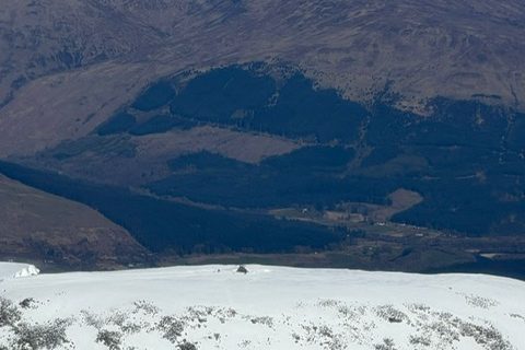 The snowy summit of Ben Nevis above Glen Nevis